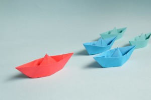 Red boat leading blue boats